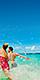 Couple Splashing at the beach, George Town, Grand Cayman | HP Mobile